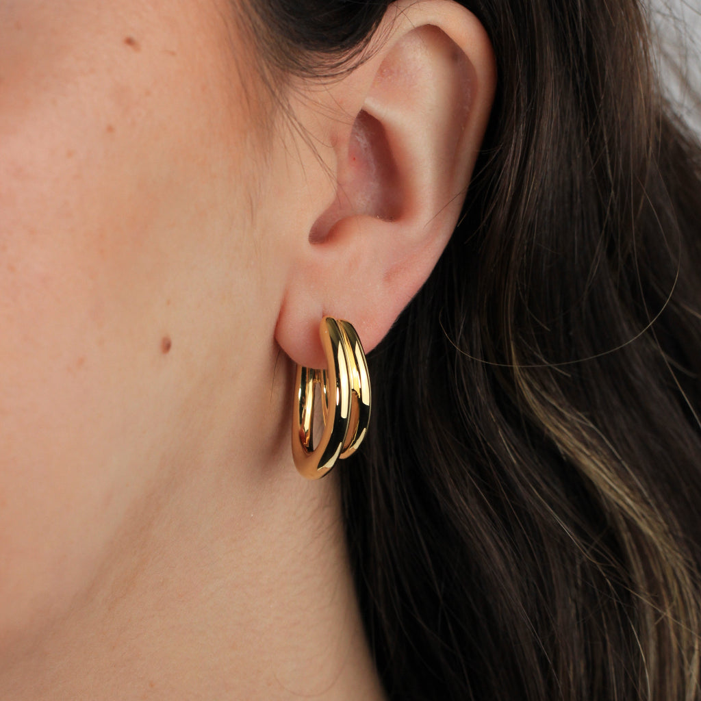 Pendientes de aro realizados en oro amarillo de 18 quilates en forma de doble tubo ovalado.