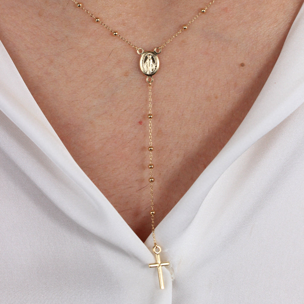 Collar rosario en oro amarillo de 18 quilates con varios motivos esféricos, una cruz y la virgen de la milagrosa.