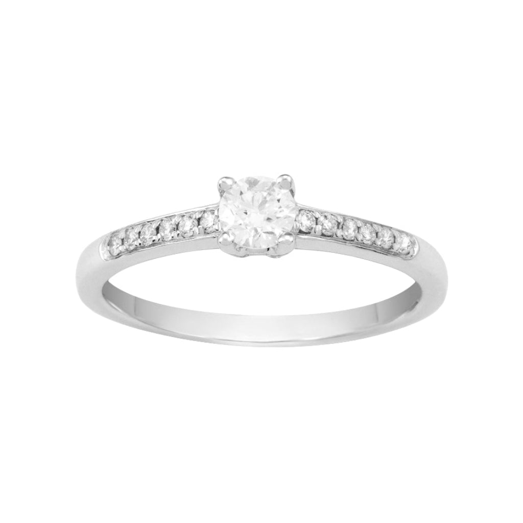 Sortija en oro blanco de 18 quilates con un diamante central engarzado en cuatro garras y un carril de diamantes en el brazo. Joyería Pamplona.