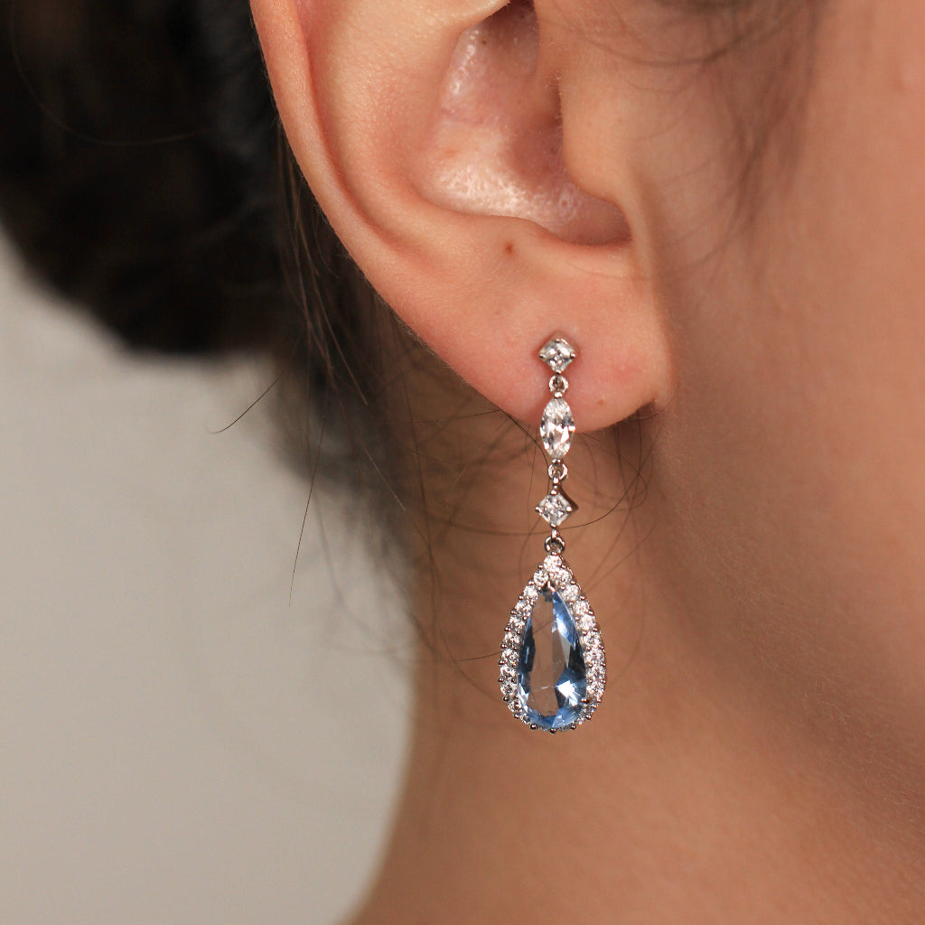 Pendientes largos realizados en plata de primera ley con una caída de circonitas incoloras y azul en forma de lágrima
