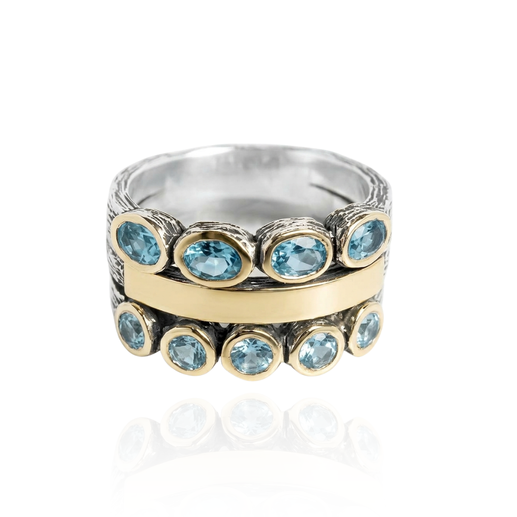Anillo de plata de ley 925 y oro de 9 k con topacios azules y topacios azules reales. Colección Gabriela Styliano.