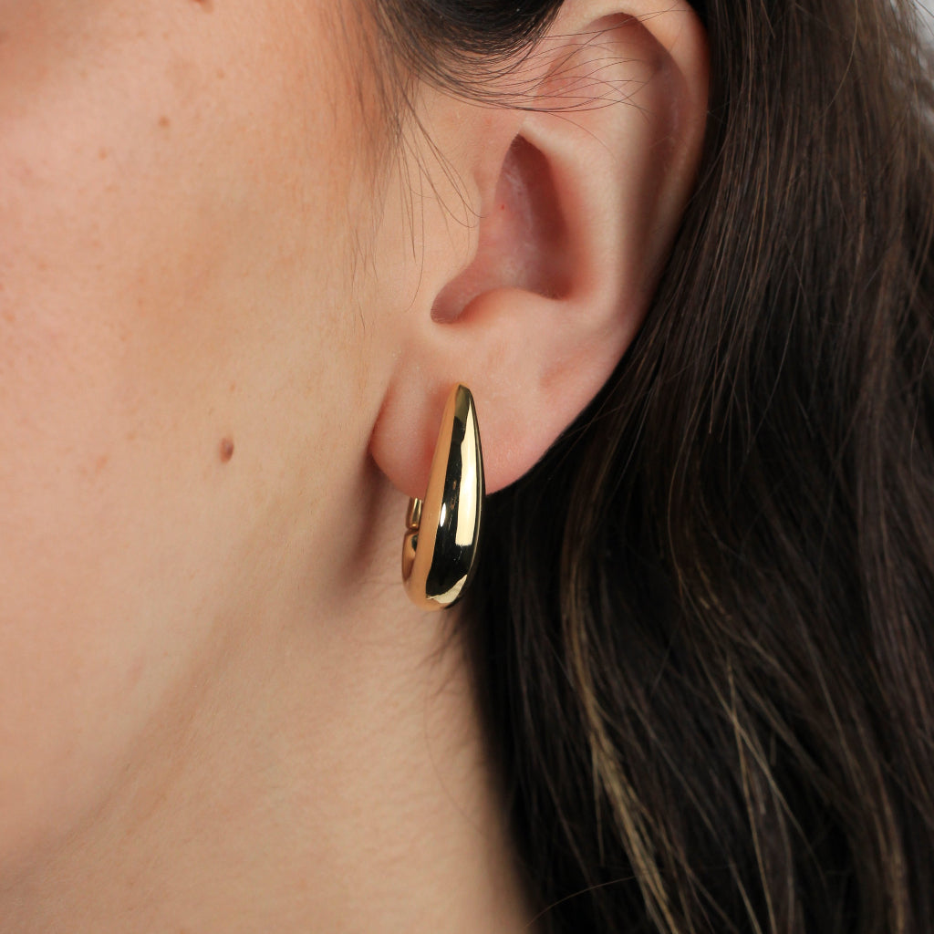 Pendientes estilo aro realizados en oro amarillo de 18 quilates con forma ovalada abombados. 