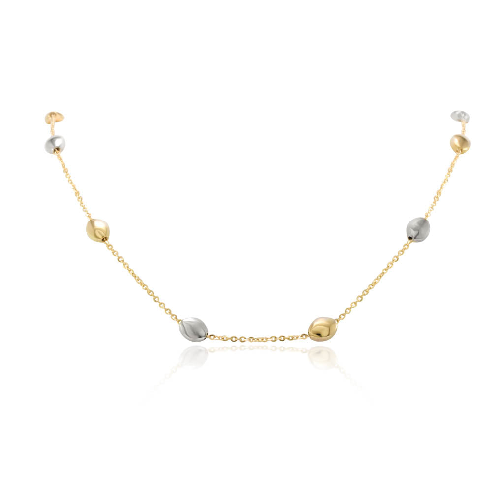Gargantilla bicolor realizada en oro amarillo y blanco de 18 quilates con una cadena forzada y motivos en forma de pepitas.