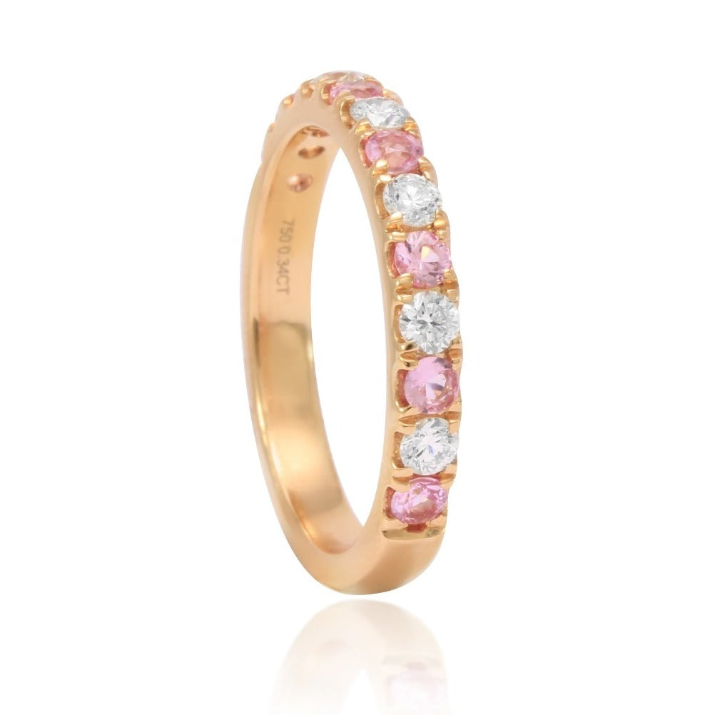 Sortija de oro rosa de 18 quilates con medio carril de zafiros rosa y 6 diamantes. Joyeria Pamplona