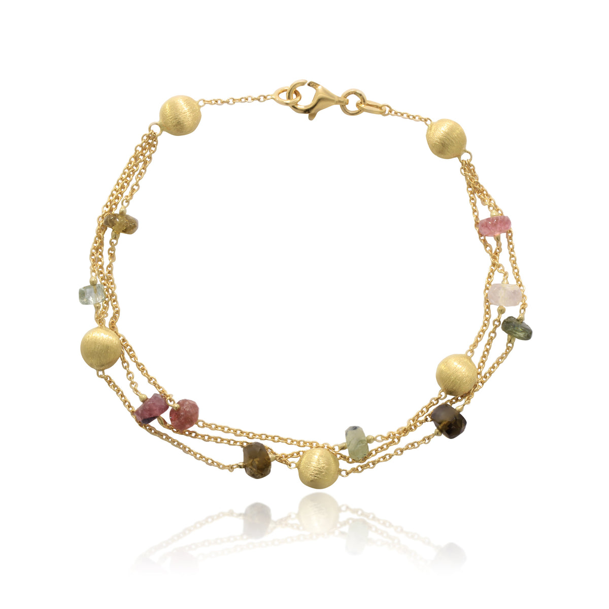 Pulsera realizada en oro amarillo de 18 quilates con tres cadenas, motivos circulares mate, y turmalinas.