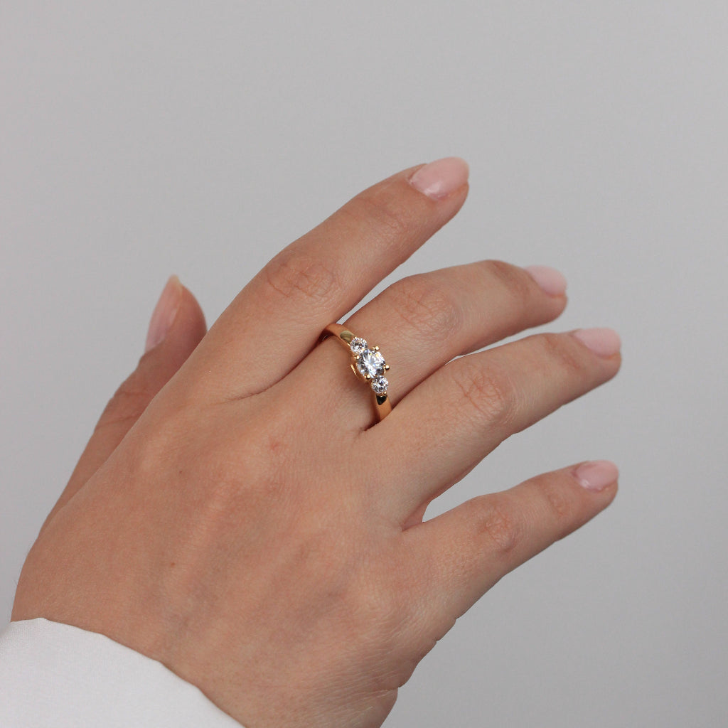 Sortija realizada en oro amarillo de 18 quilates con tres circonitas incoloras.