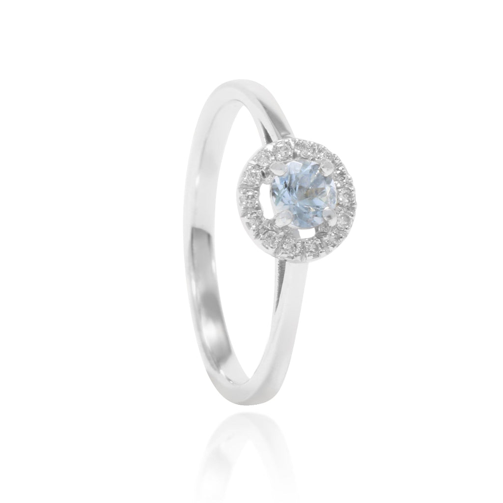 Anillo de oro blanco de 18 quilates con un aguamarina central y una orla de diamantes