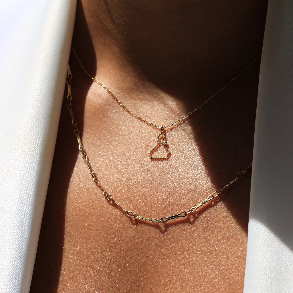 Collar y colgante san fermin de oro 18k