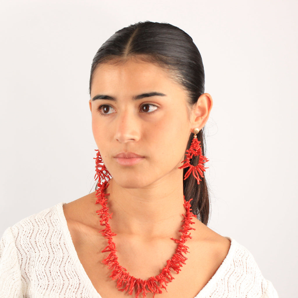 Pendientes realizados en oro amarillo de 18 quilates con acabado matizado y ramificaciones irregulares de coral rojo.