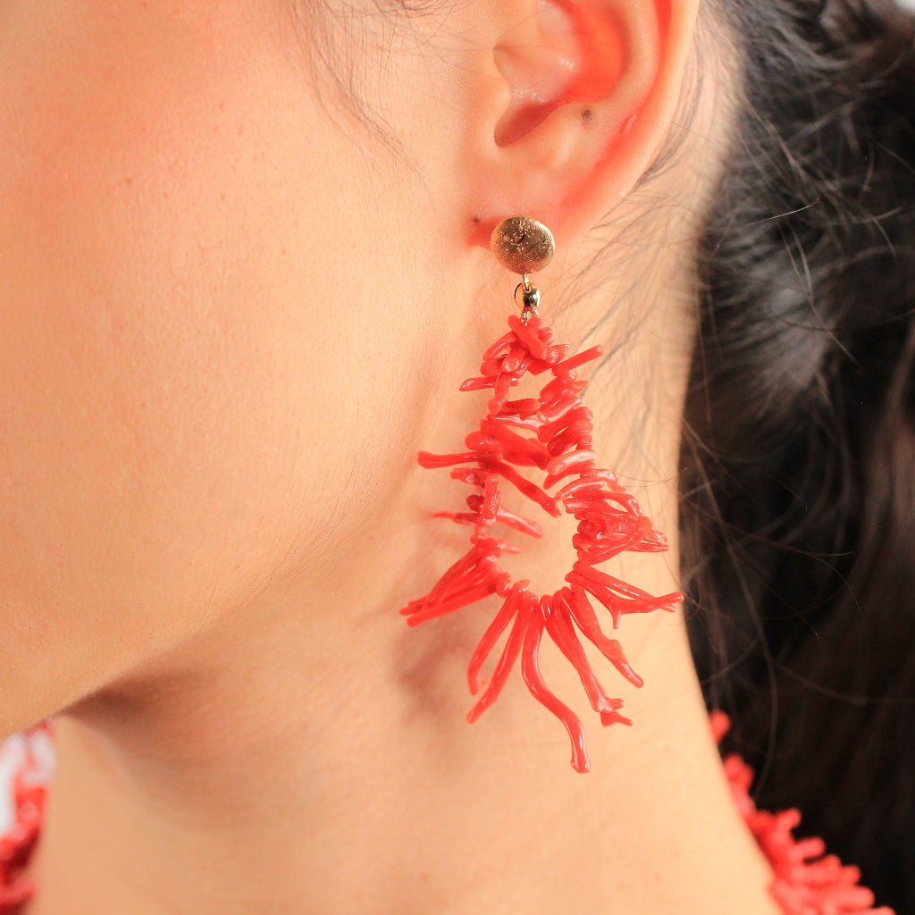 Pendientes realizados en oro amarillo de 18 quilates con acabado matizado y ramificaciones irregulares de coral rojo.