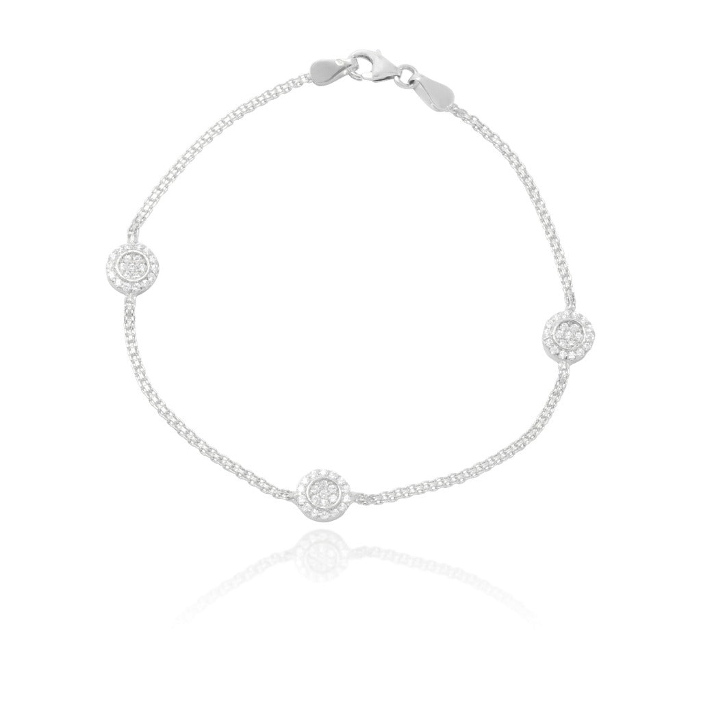 Pulsera realizada en oro blanco de 18 quilates con motivos circulares cuajados con circonitas.