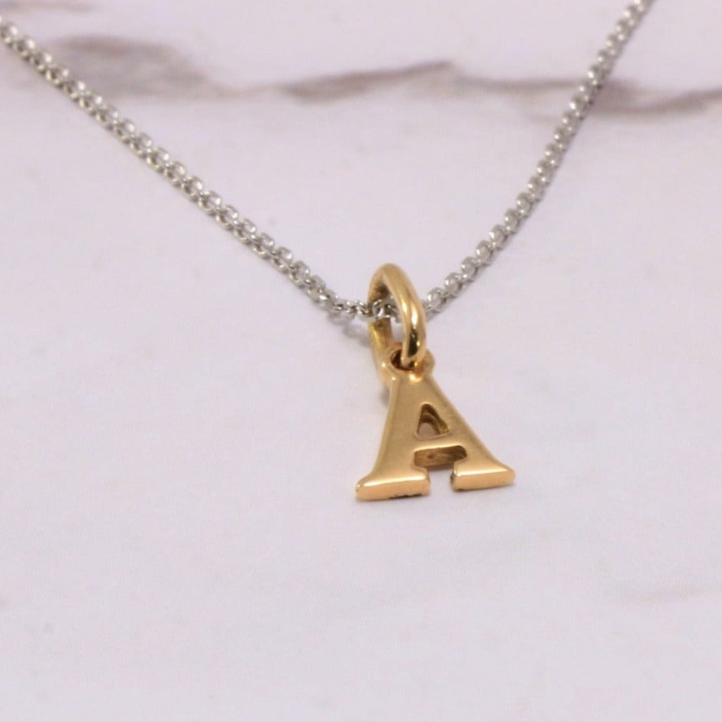 Cadena en oro blanco de 18 quilates con inicial en oro rosa de 18 quilates. Joyería Pamplona.